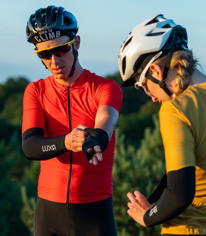 man and woman wearing arm warmers because of chill evening during cycling