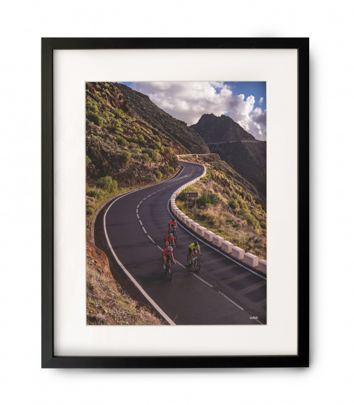 A bicycle poster with a frame for a cyclist on the wall in the form of a gift with a view of Tenerife.