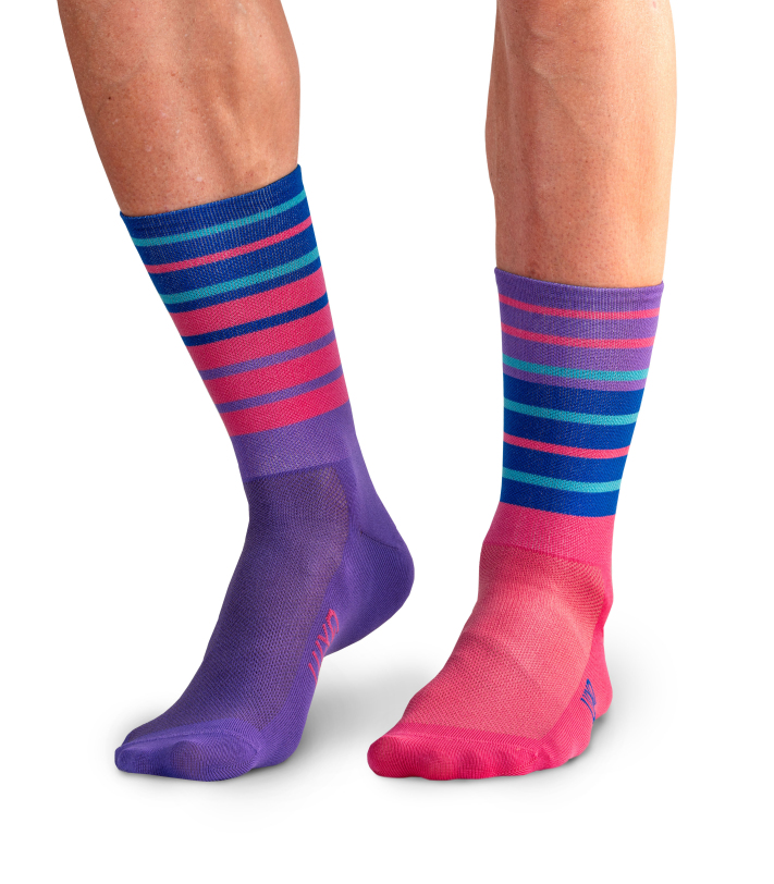 Cyclist wearing purple and blue striped socks during a ride.