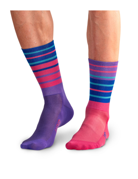 Cyclist wearing purple and blue striped socks during a ride.