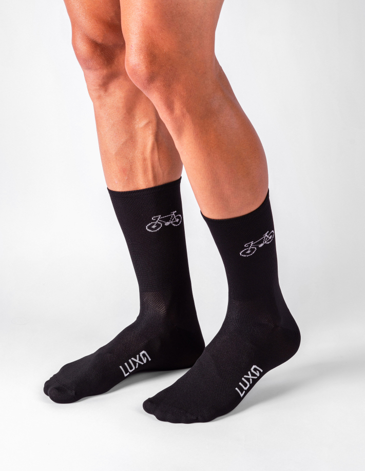shaved cyclist legs wearing socks with bicycle graphics