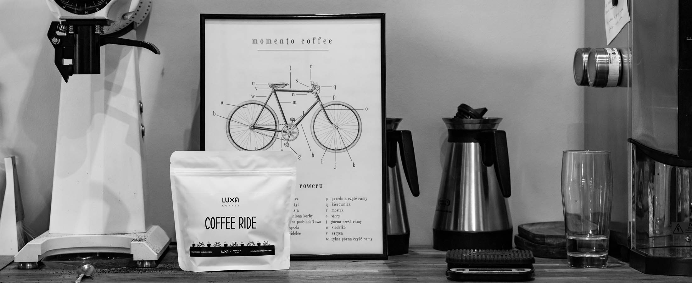 interior of a cafe with an atmospheric picture with a bicycle and coffee for cyclists Luxa Coffee Ride from the Momento roaster in Rzeszów