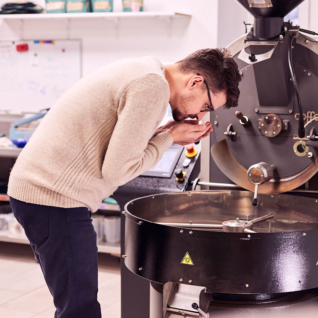 Kamil from Momento roastery smelling cycling coffee beans from Brasil
