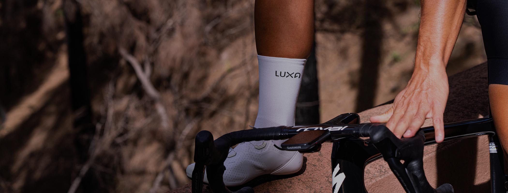 male cyclist wearing white Luxa cycling socks
